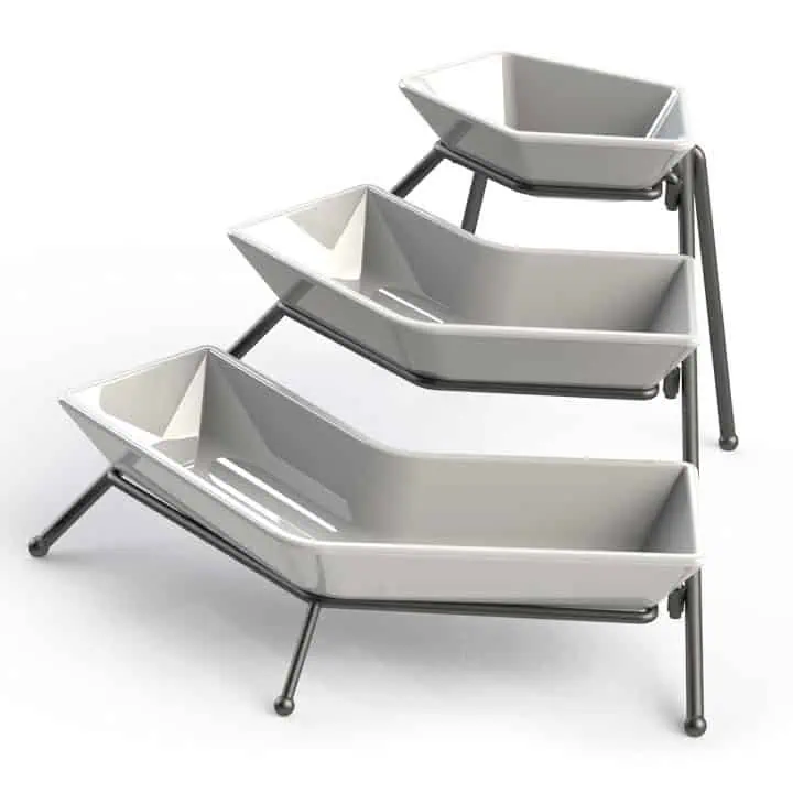 Three modern, white, hexagonal trays are stacked at an angle on a sleek, black metal frame, creating a tiered, minimalist display stand.