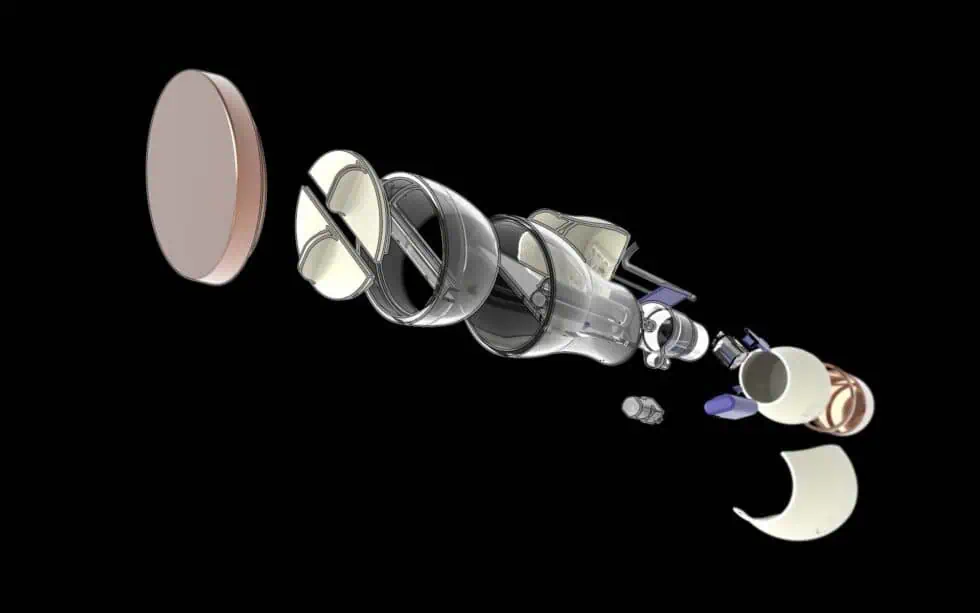 An exploded view of a mechanical object with various cylindrical and circular components separated and aligned on a black background, displaying the internal parts and structure.