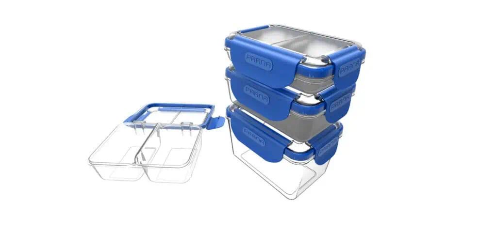 Three stainless steel lunch boxes with blue lids stacked on top of each other, next to two open containers with transparent lids, all on a white background.