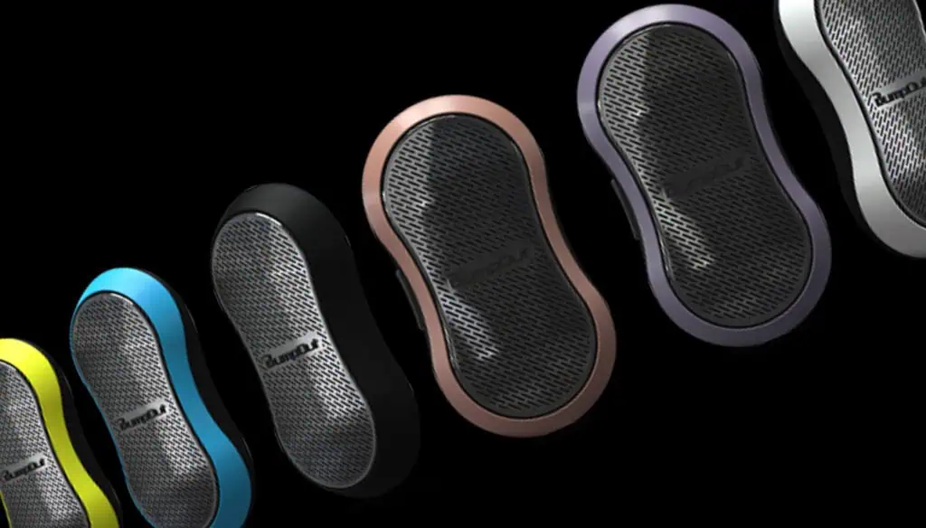 Five handheld, oval-shaped electronic devices in different colors (yellow, blue, black, bronze, and purple) are displayed in a diagonal row on a black background. The devices have metallic mesh fronts.