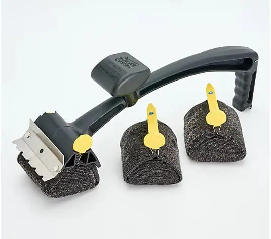 A black-handled grill cleaning brush with a metal scraper and two replacement scrub pads, all placed on a white background. The pads have yellow plastic holders attached.