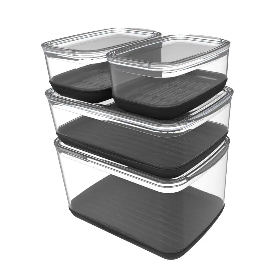Four transparent rectangular food storage containers with black lids are stacked neatly on top of each other. The containers are empty and shown against a plain white background.