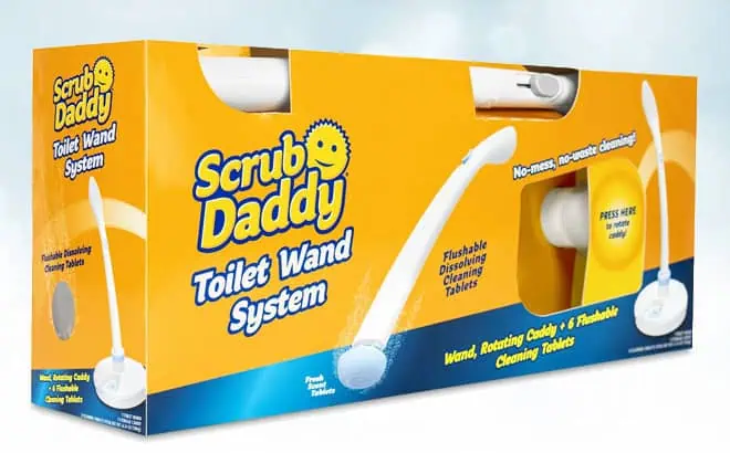 A yellow Scrub Daddy Toilet Wand System box is shown, featuring a white toilet wand and cleaning tablets. The packaging highlights no-mess cleaning and flushable tablets, with product images and text on the front.
